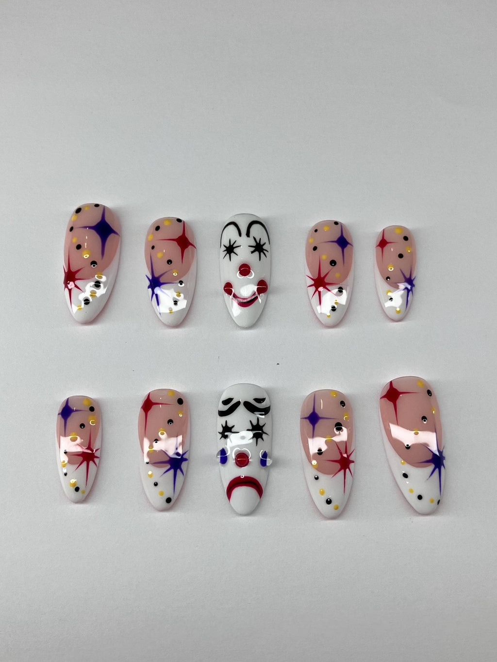 Clowning around press on nails with clown face design, application pack included.