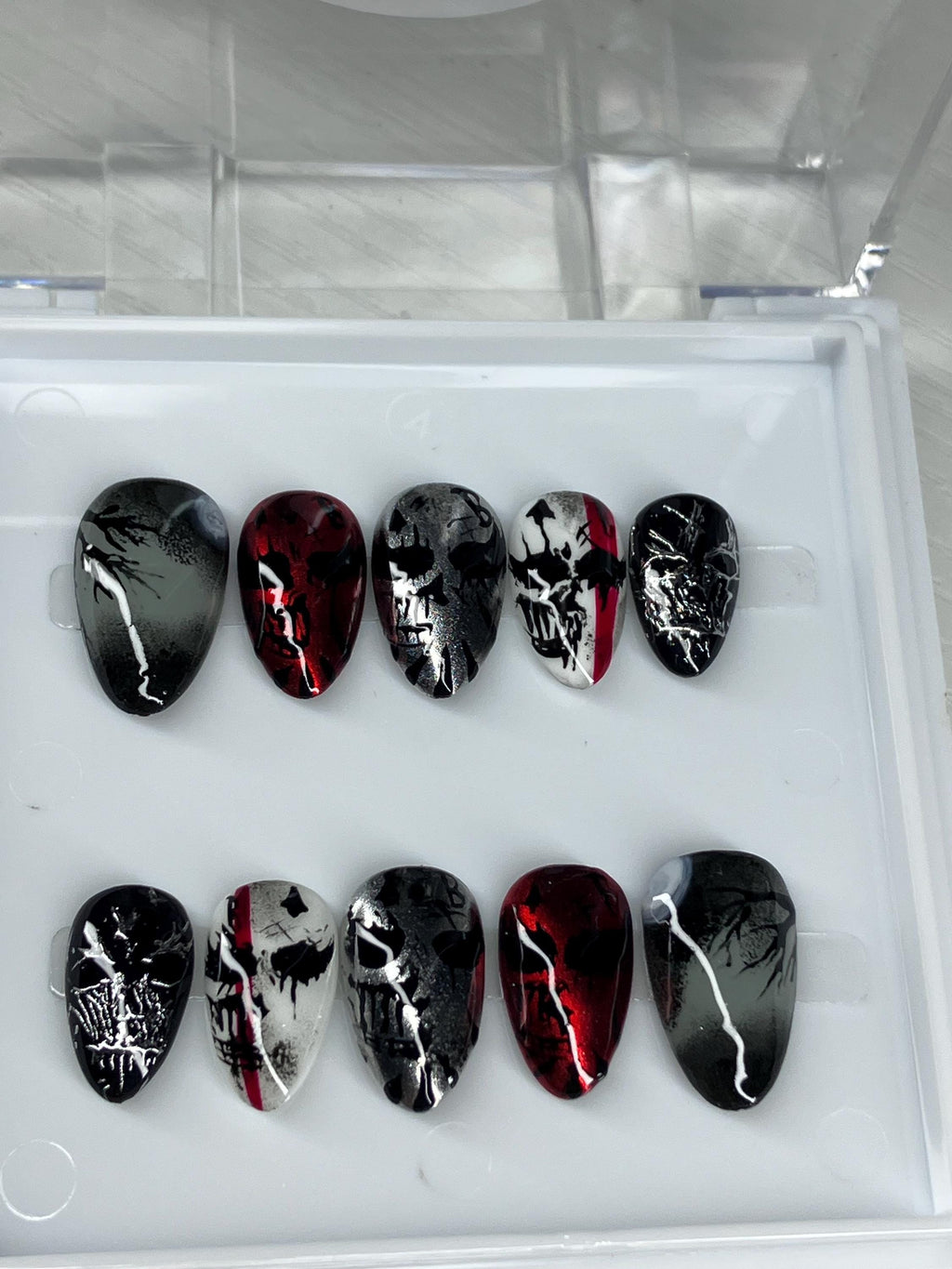 Chrome mask design press on nails with application pack included.