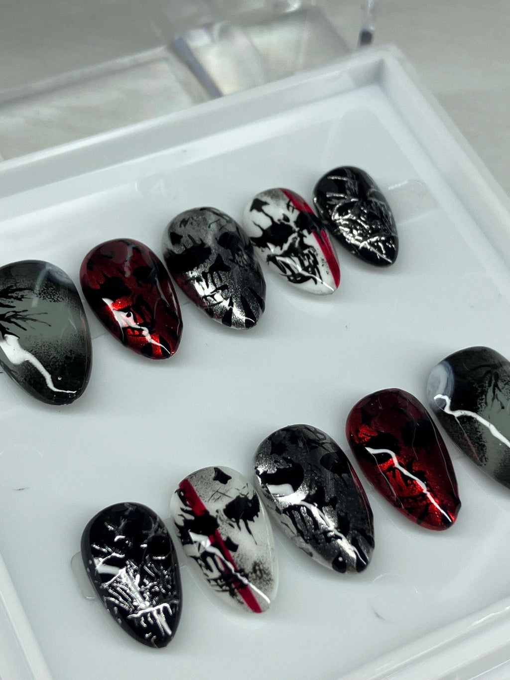 Chrome mask design press on nails with application pack included.
