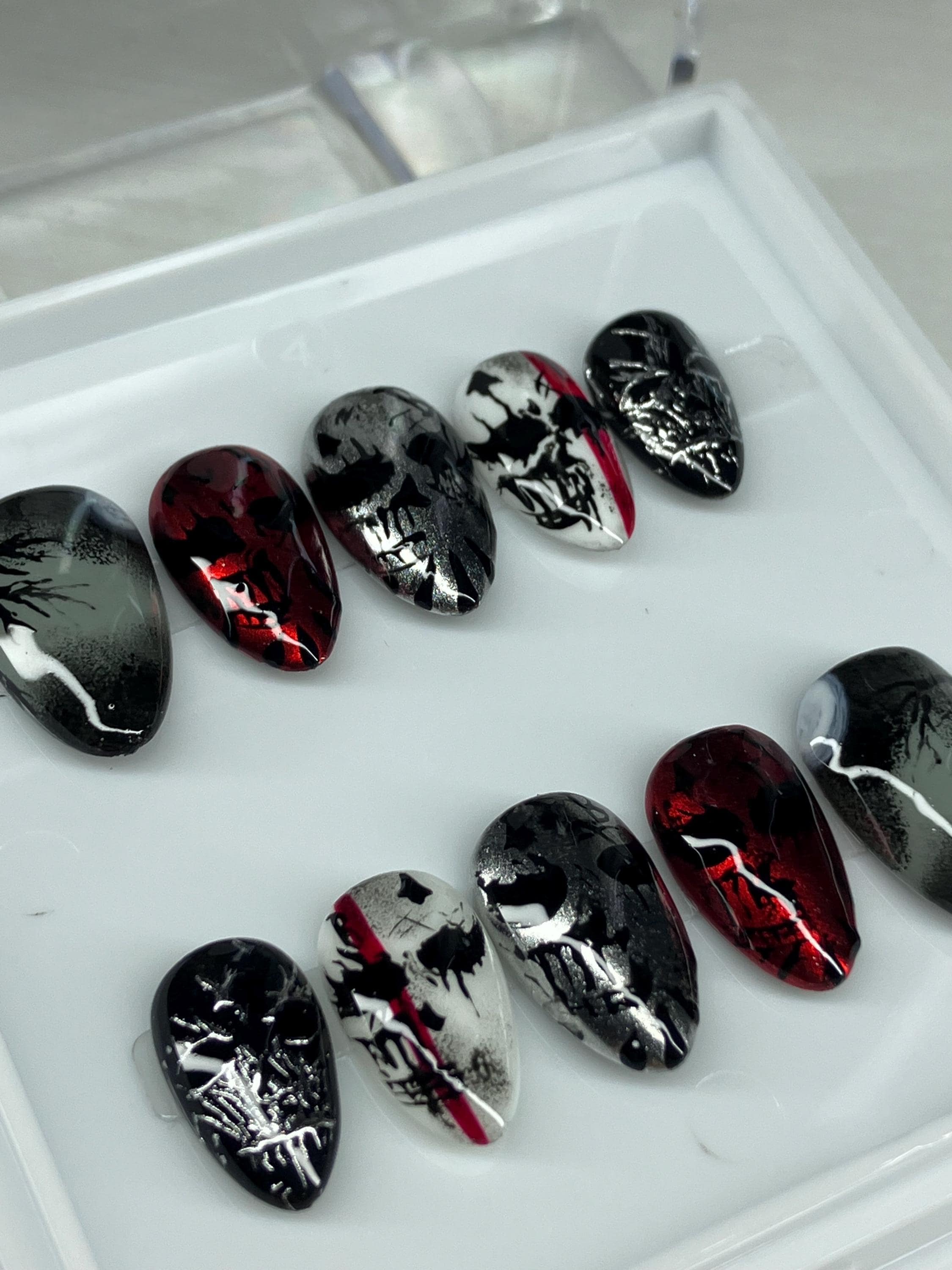 Chrome mask design press on nails with application pack included.