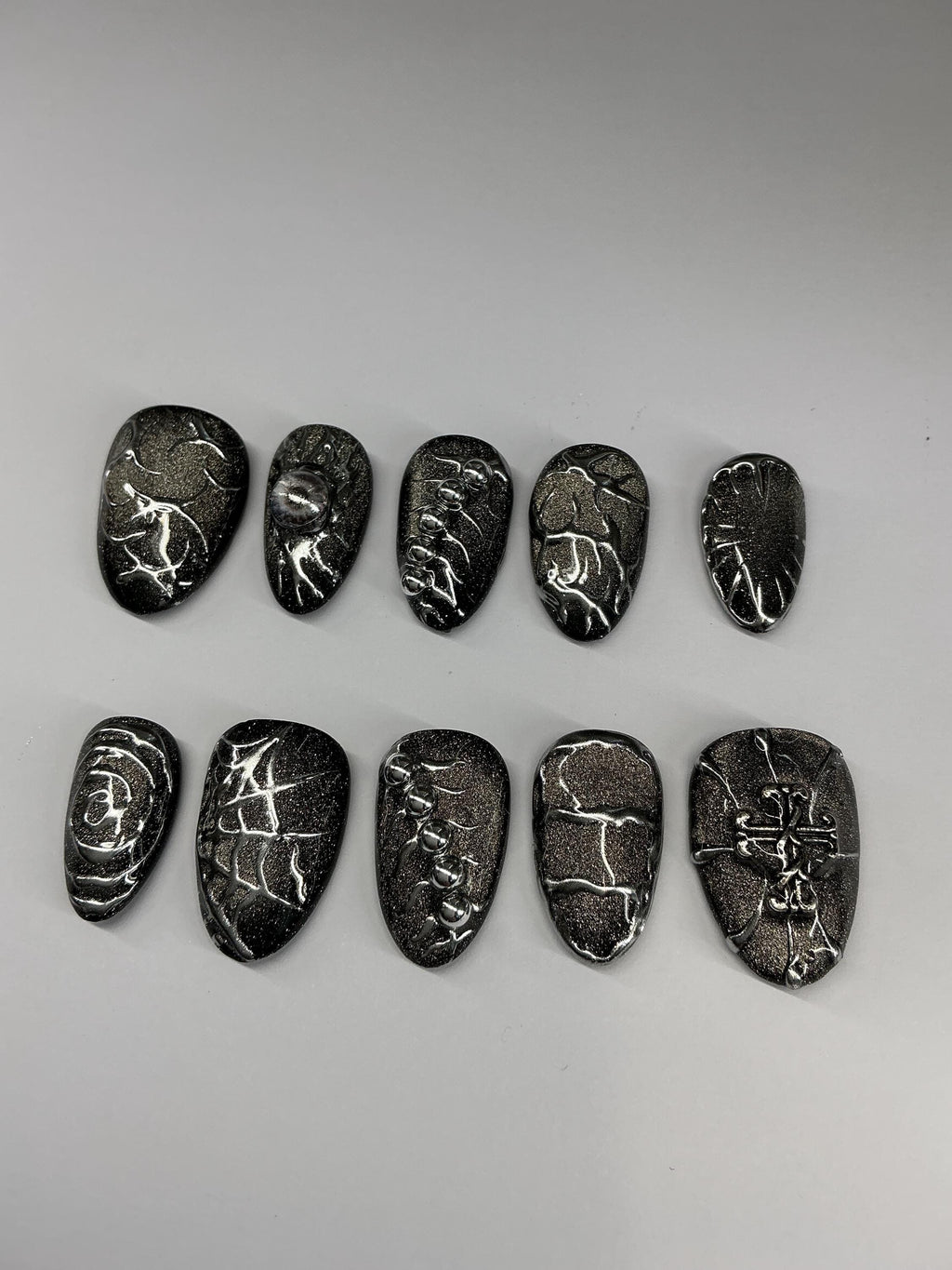 Gothic cat eye and chrome press on nails with application pack.