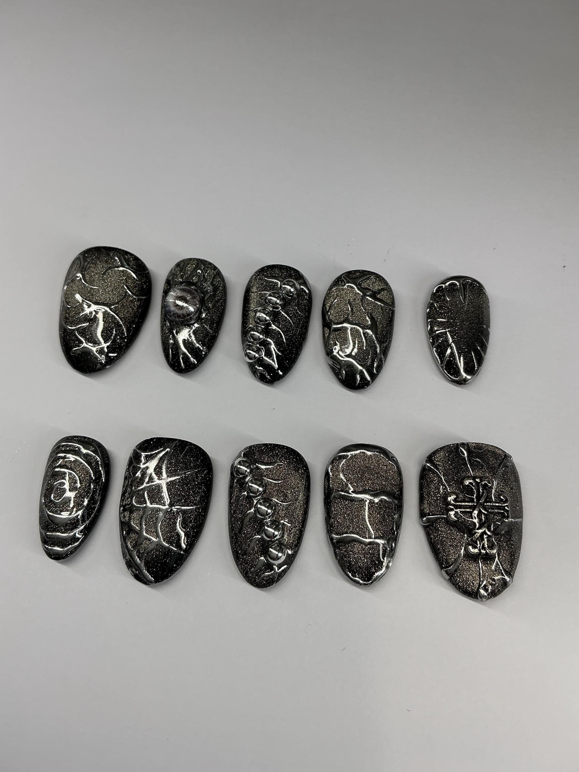 Gothic cat eye and chrome press on nails with application pack.