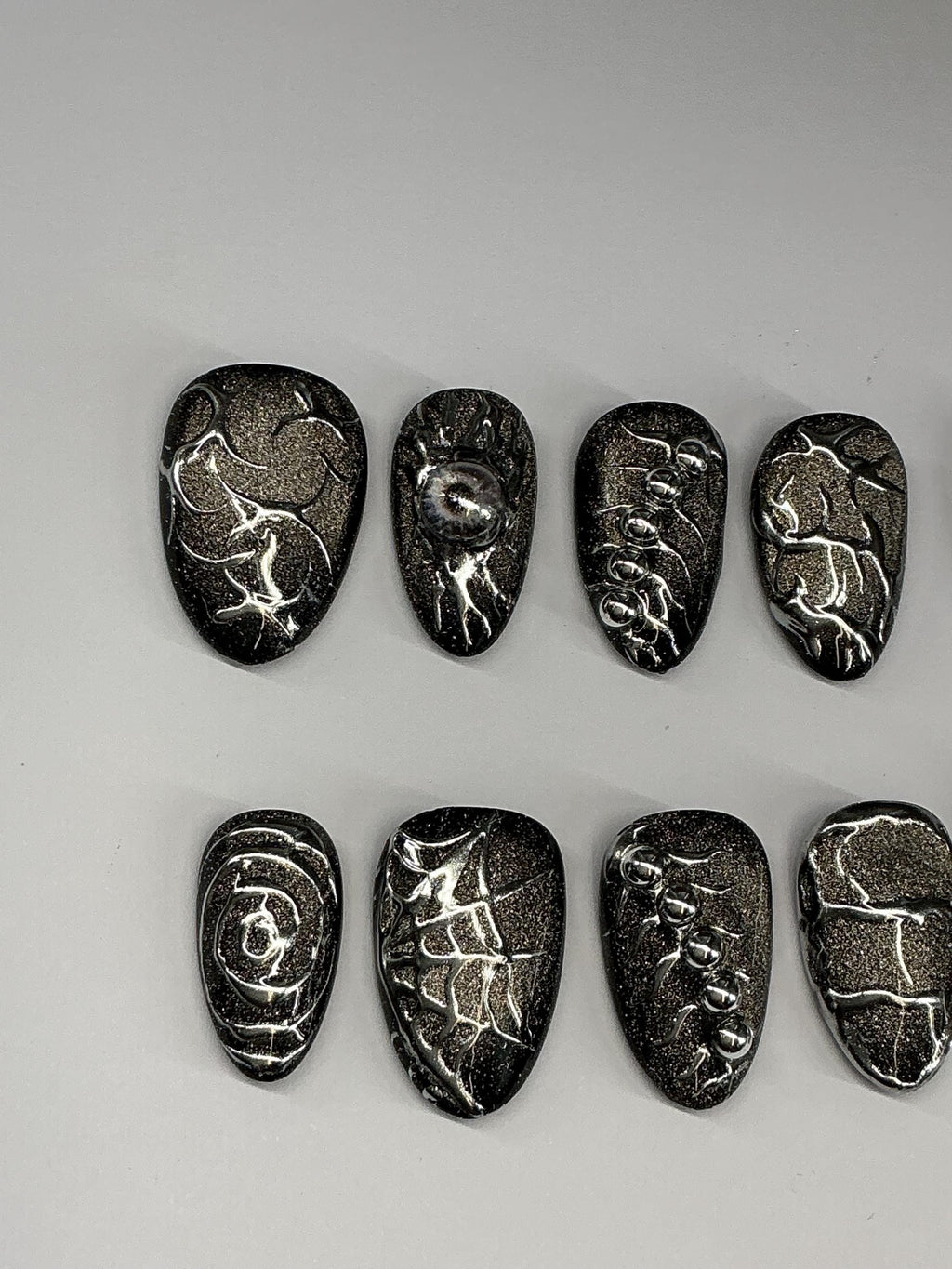 Gothic cat eye and chrome press on nails with application pack.