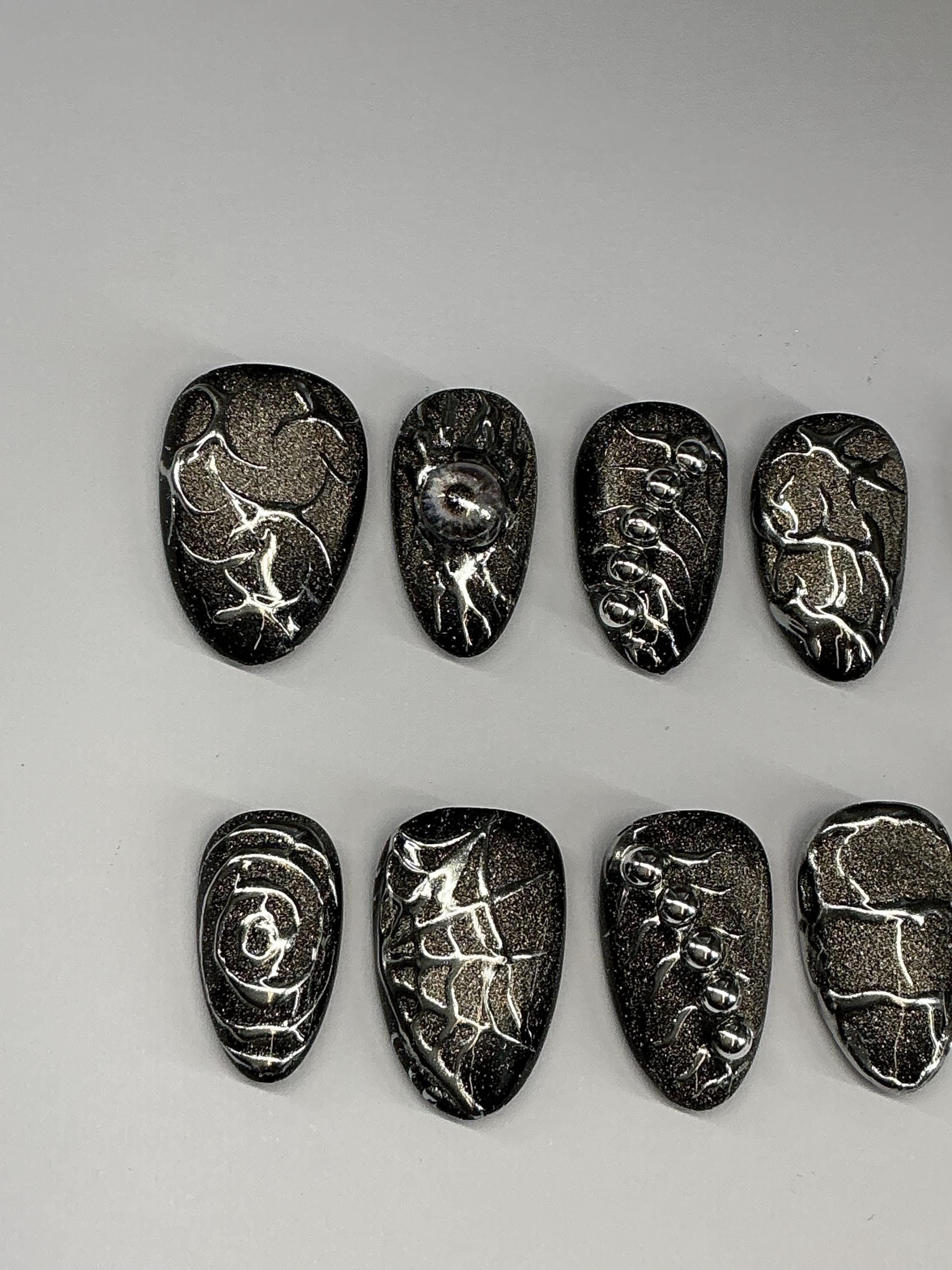 Gothic cat eye and chrome press on nails with application pack.